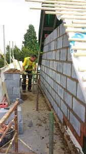 One of the gable ends being built.  The scaffold boards were covered with hardboard reducing falling debris & the sides were also cladded.